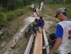 Anggota Satgas Yonif 144/JY Bantu Warga Benahi Jalan Desa Yang Berlobang di Perbatasan